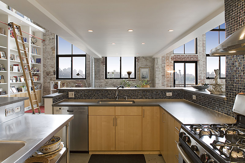 330 Wythe Avenue, Unit 4J Brooklyn, NY 11249 - Photo 4 of 6 a kitchen with stainless steel appliances granite countertop a sink stove and cabinets