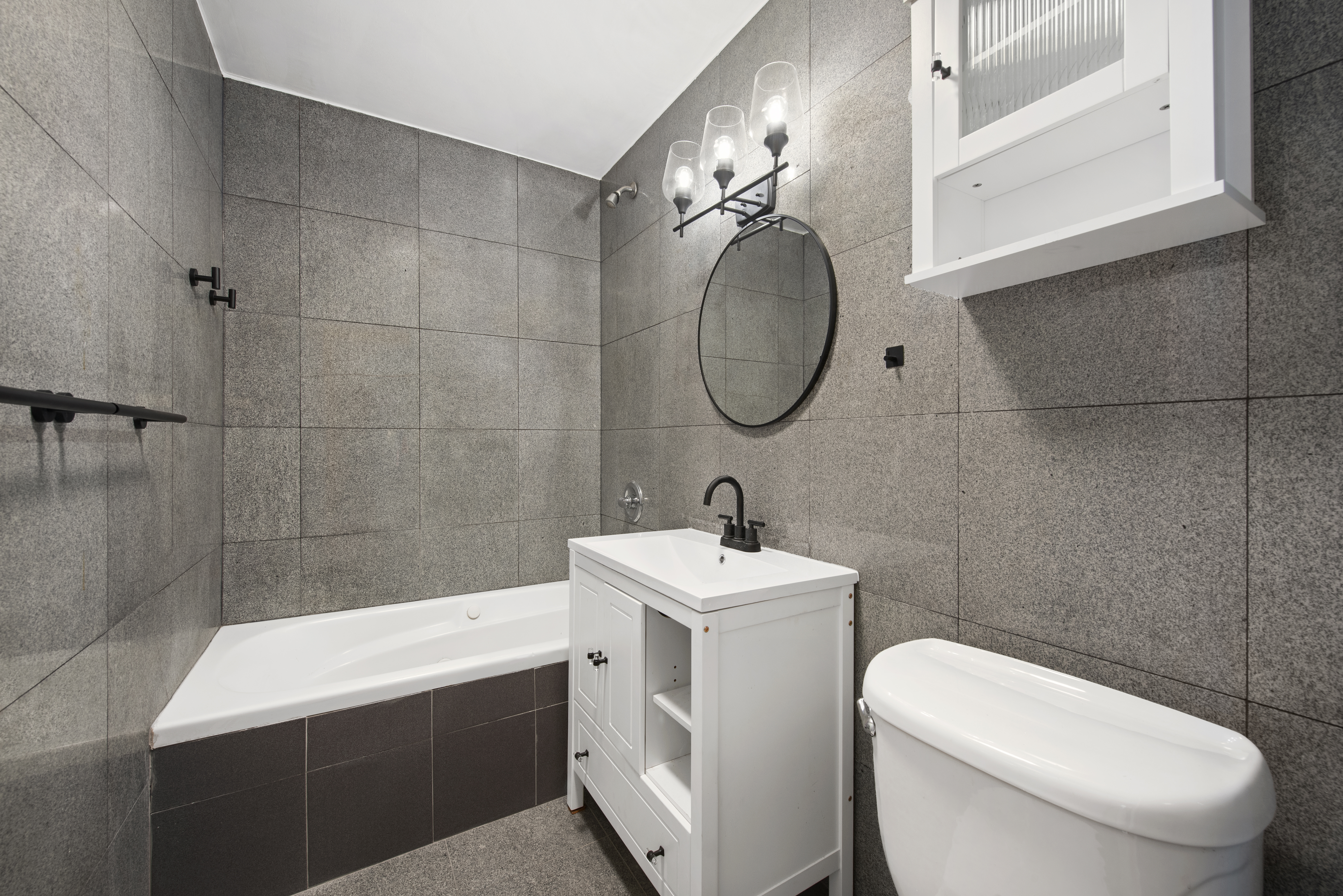 336 Convent Avenue, Unit MLTFMLY Manhattan, NY 10031 - Photo 7 of 20 a bathroom with a toilet sink and mirror