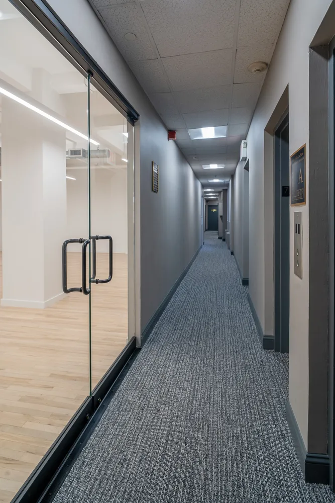a view of a hallway with wooden floor