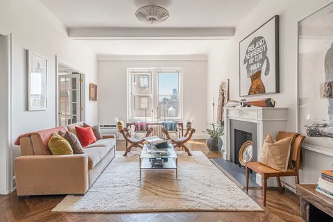 a living room with furniture fireplace and window