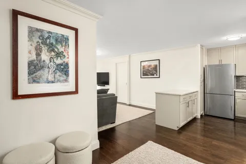 a white refrigerator freezer sitting inside of a kitchen