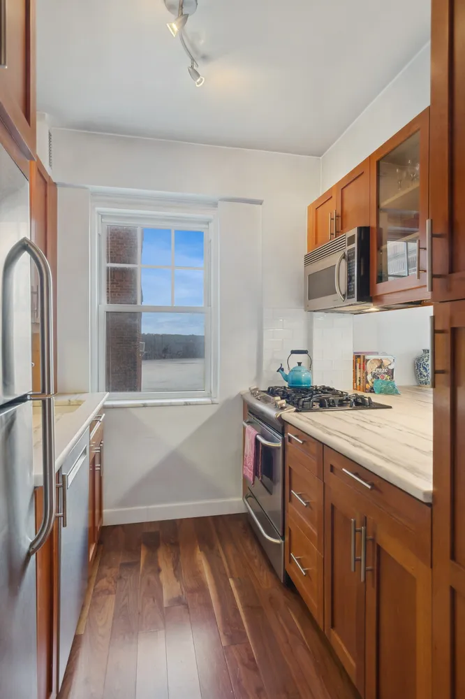 a kitchen with stainless steel appliances granite countertop a stove and a refrigerator