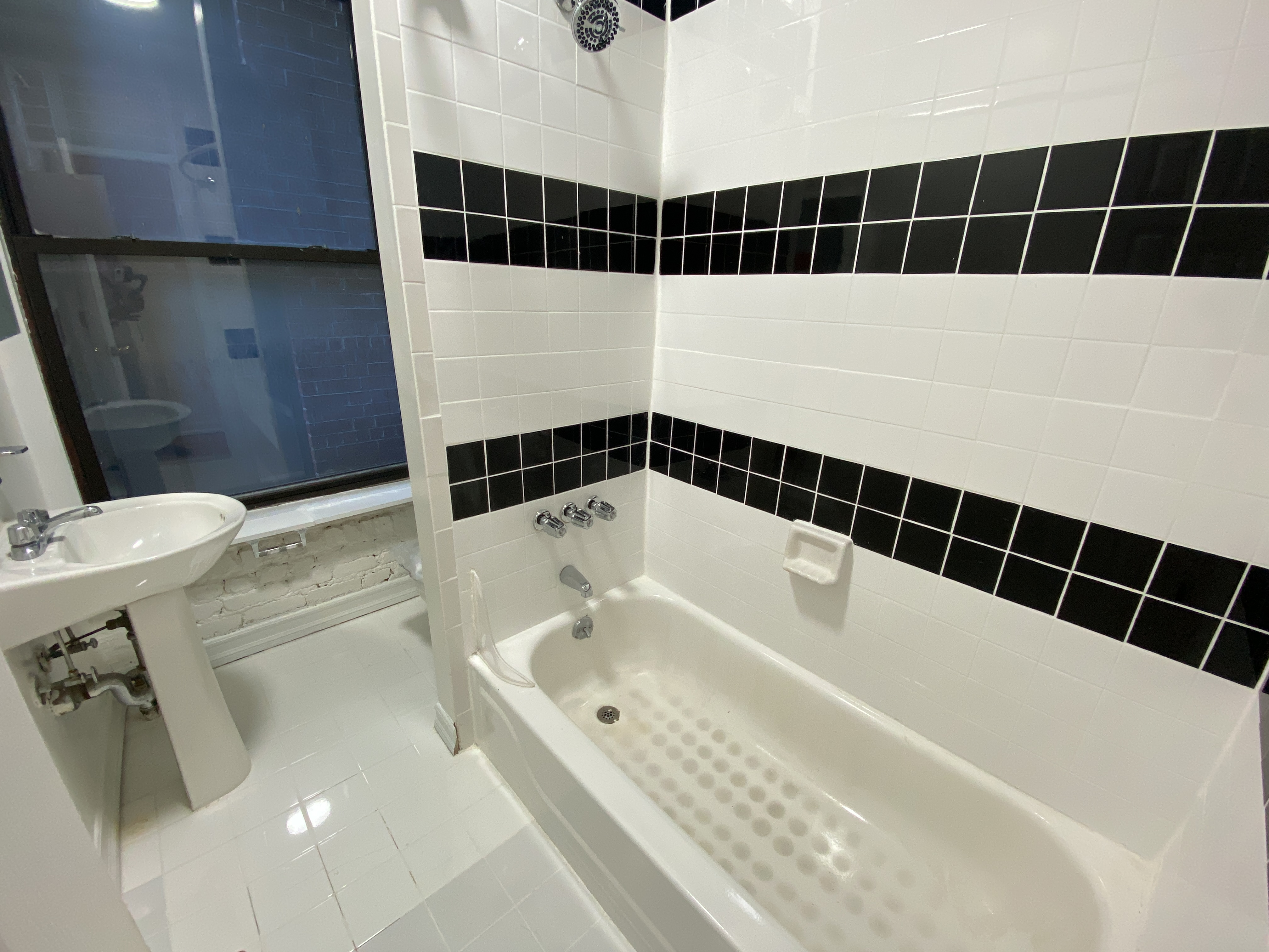 435 East 75th Street, Unit 10 Manhattan, NY 10021 - Photo 5 of 6 a bathroom with a bathtub and a shower