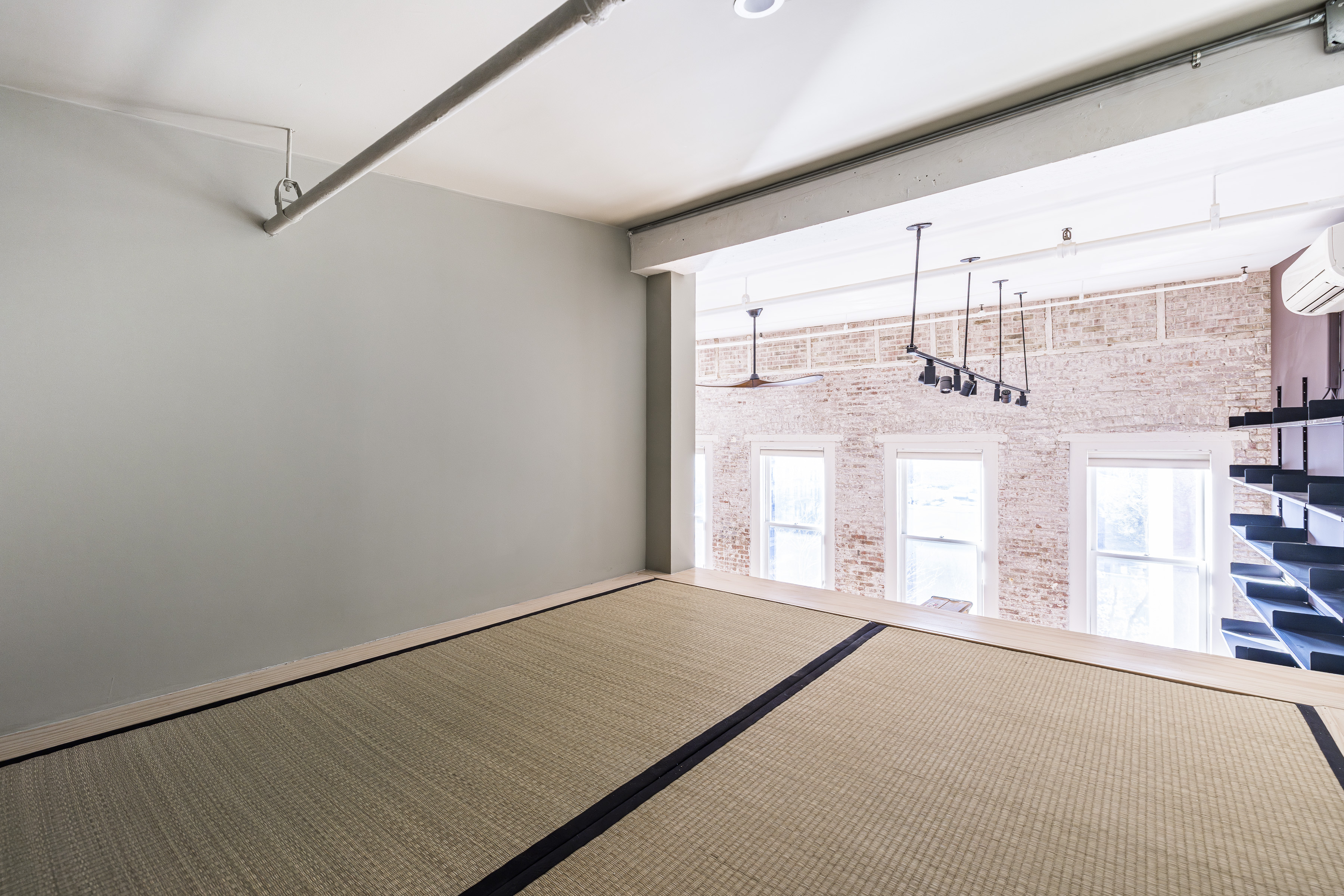 705 Driggs Avenue, Unit 13 Brooklyn, NY 11211 - Photo 4 of 15 a view of empty room with wooden floor and fan