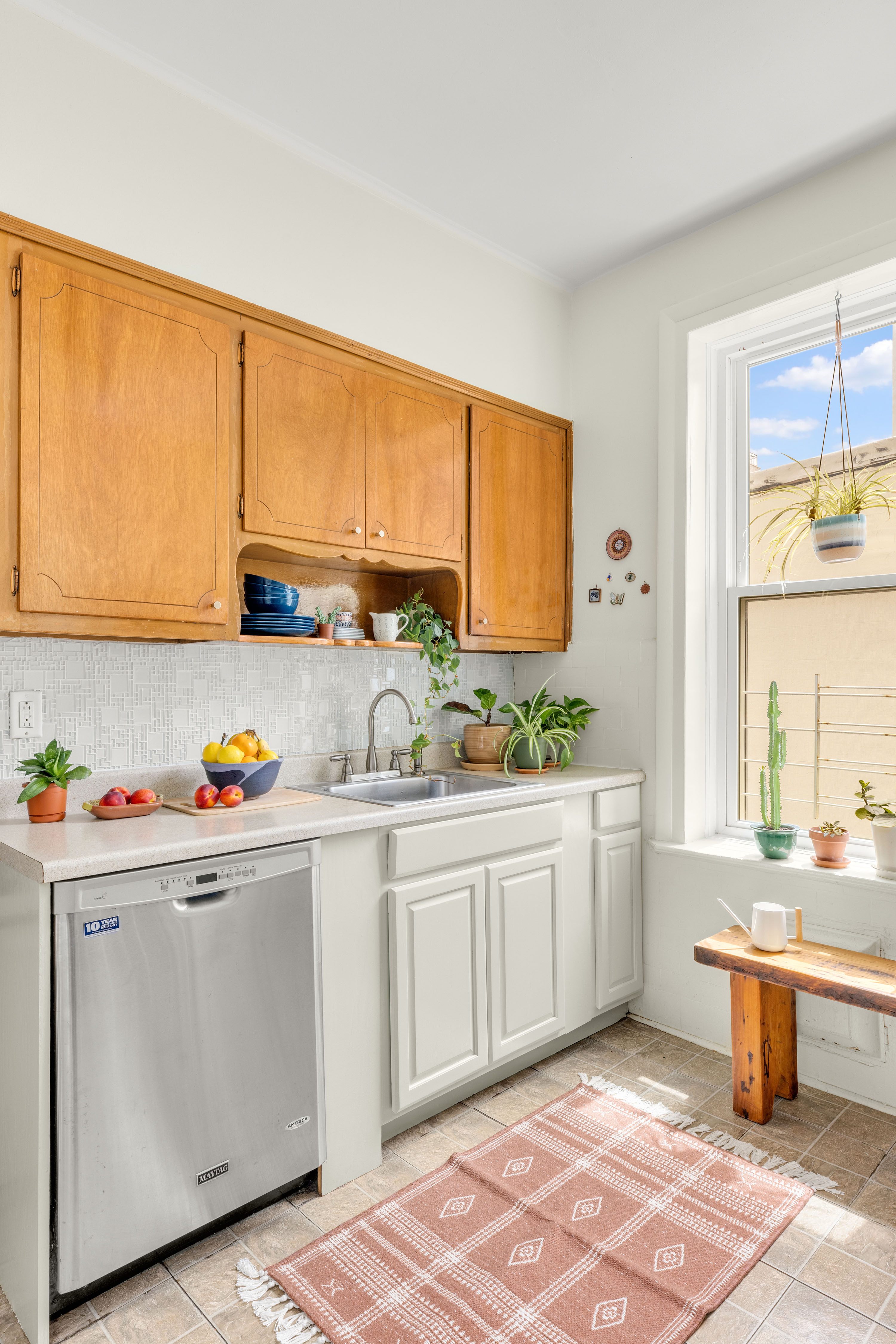 765 42nd Street, Unit 20 Brooklyn, NY 11232 - Photo 7 of 10 a kitchen with stainless steel appliances a sink a stove and white cabinets next to a window