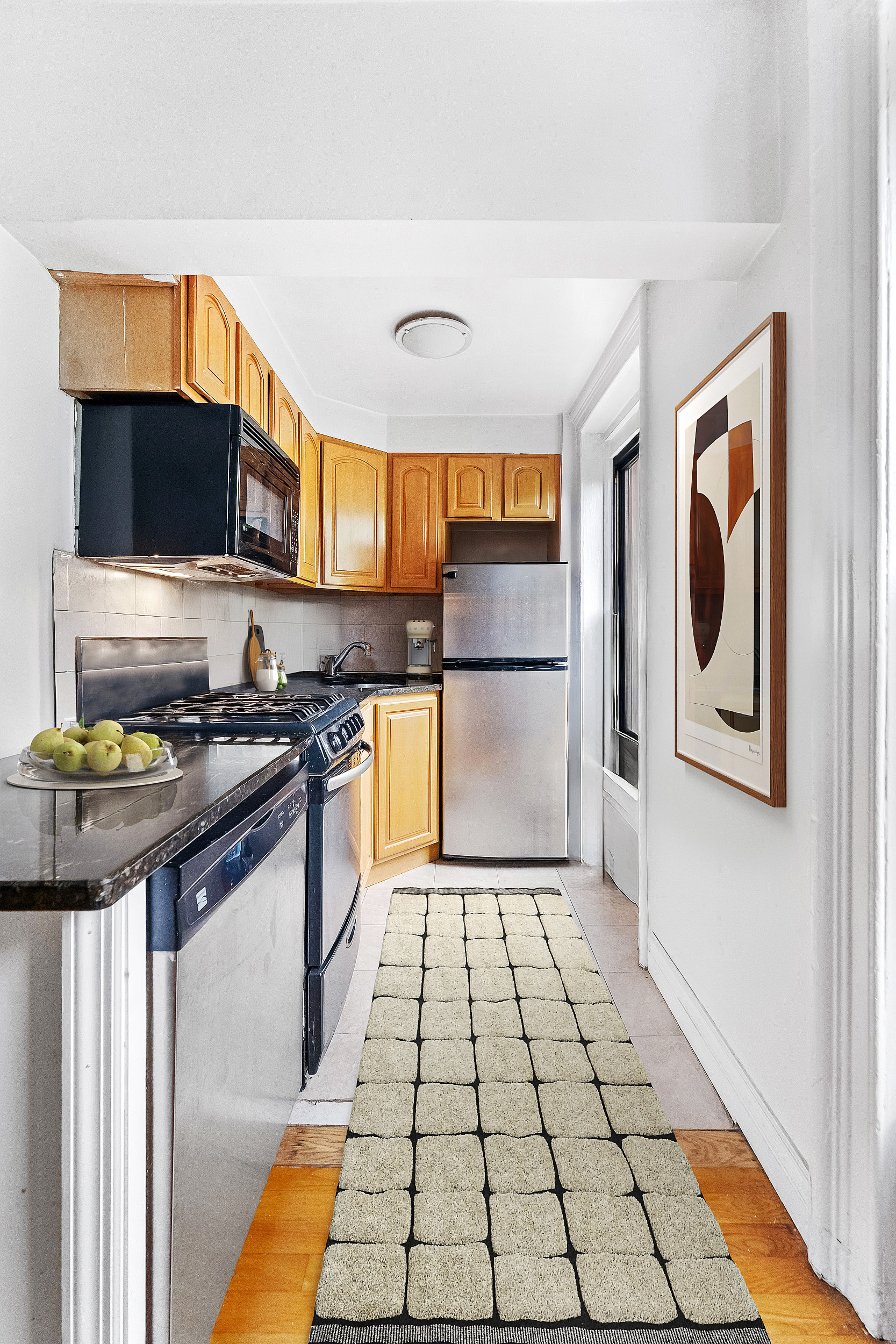 367 Degraw Street, Unit 2 Brooklyn, NY 11231 - Photo 3 of 7 a kitchen with granite countertop a stove and a microwave