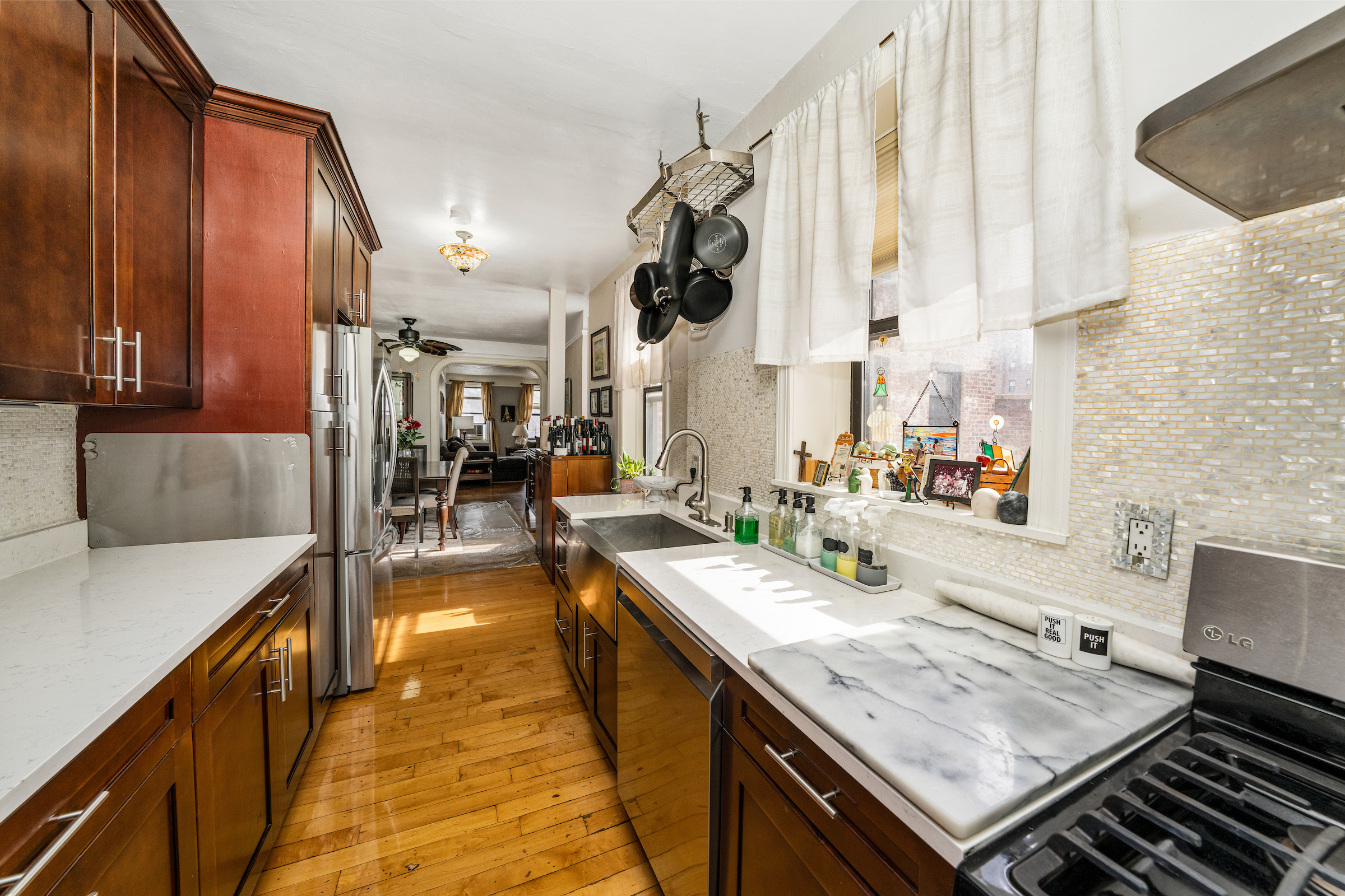 47-20 42nd Street, Unit 1H Queens, NY 11104 - Photo 5 of 11 a kitchen with a stove and a sink