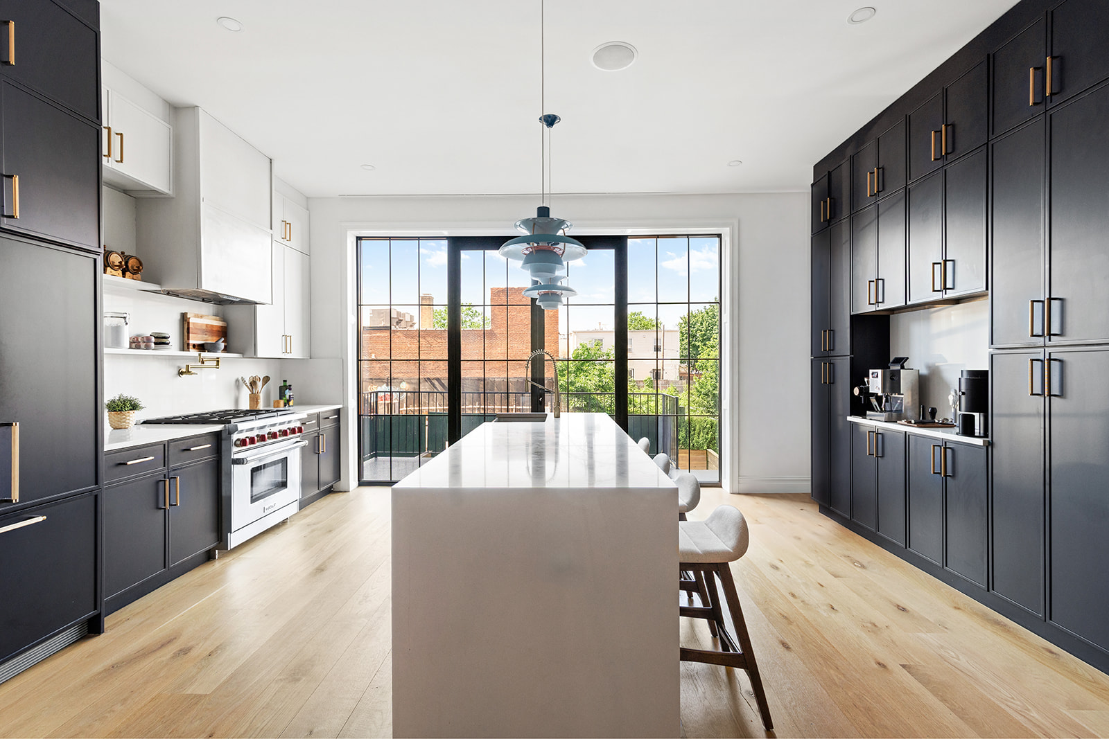 17 Linden Street Brooklyn, NY 11221 - Photo 6 of 19 a large kitchen with a large window and stainless steel appliances