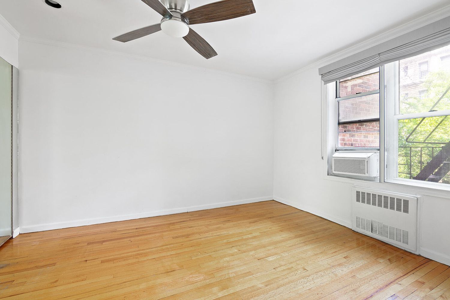 302 East 88th Street, Unit 3F Manhattan, NY 10128 - Photo 4 of 6 a view of an empty room with a window