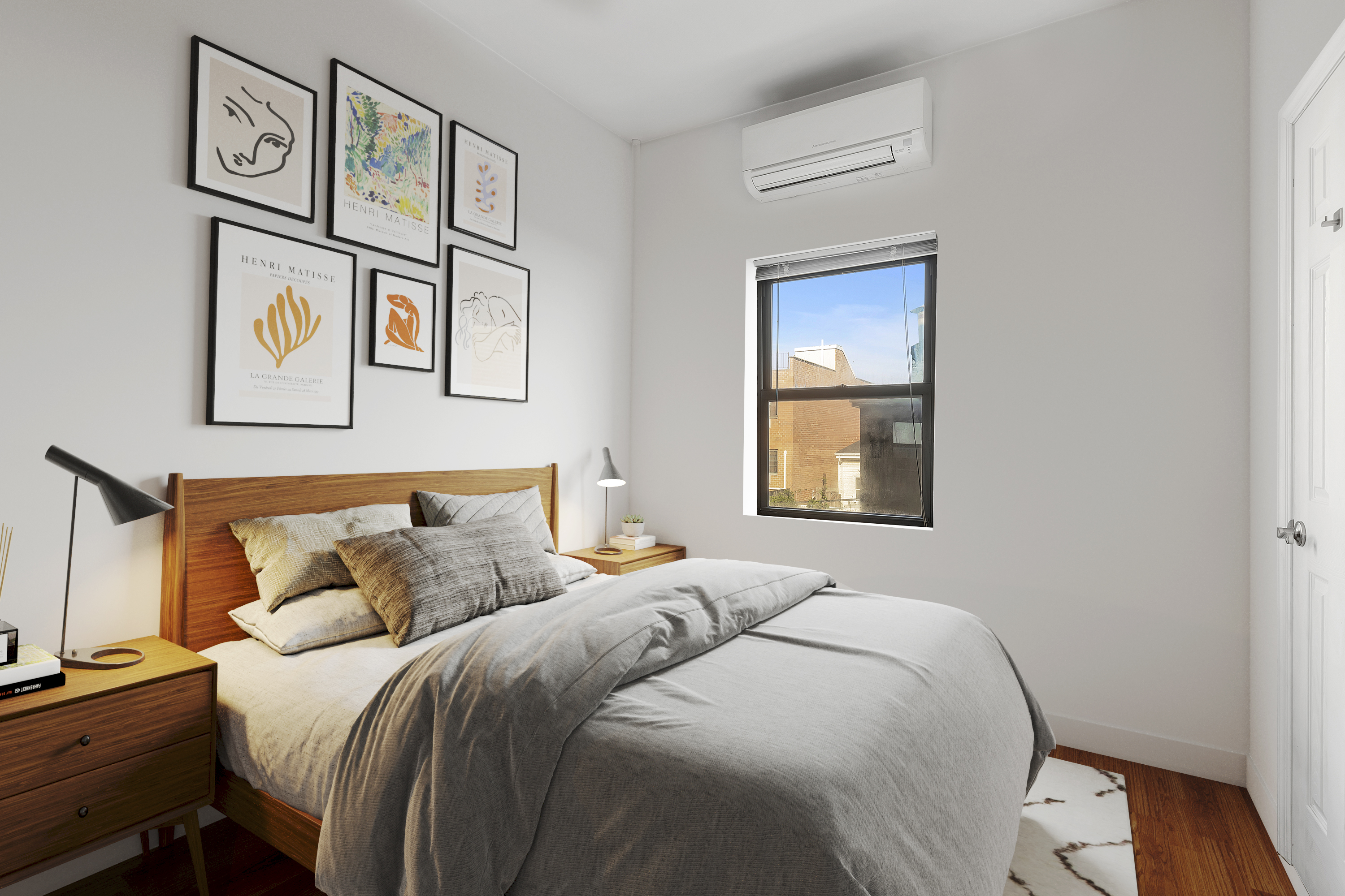 34-57 9th Street Queens, NY 11106 - Photo 6 of 10 a bed room with a bed and painting on the wall