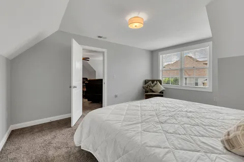 an empty room with windows and ceiling fan