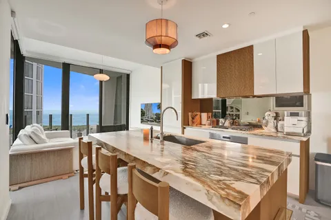 a kitchen with stainless steel appliances granite countertop a sink a stove and a refrigerator