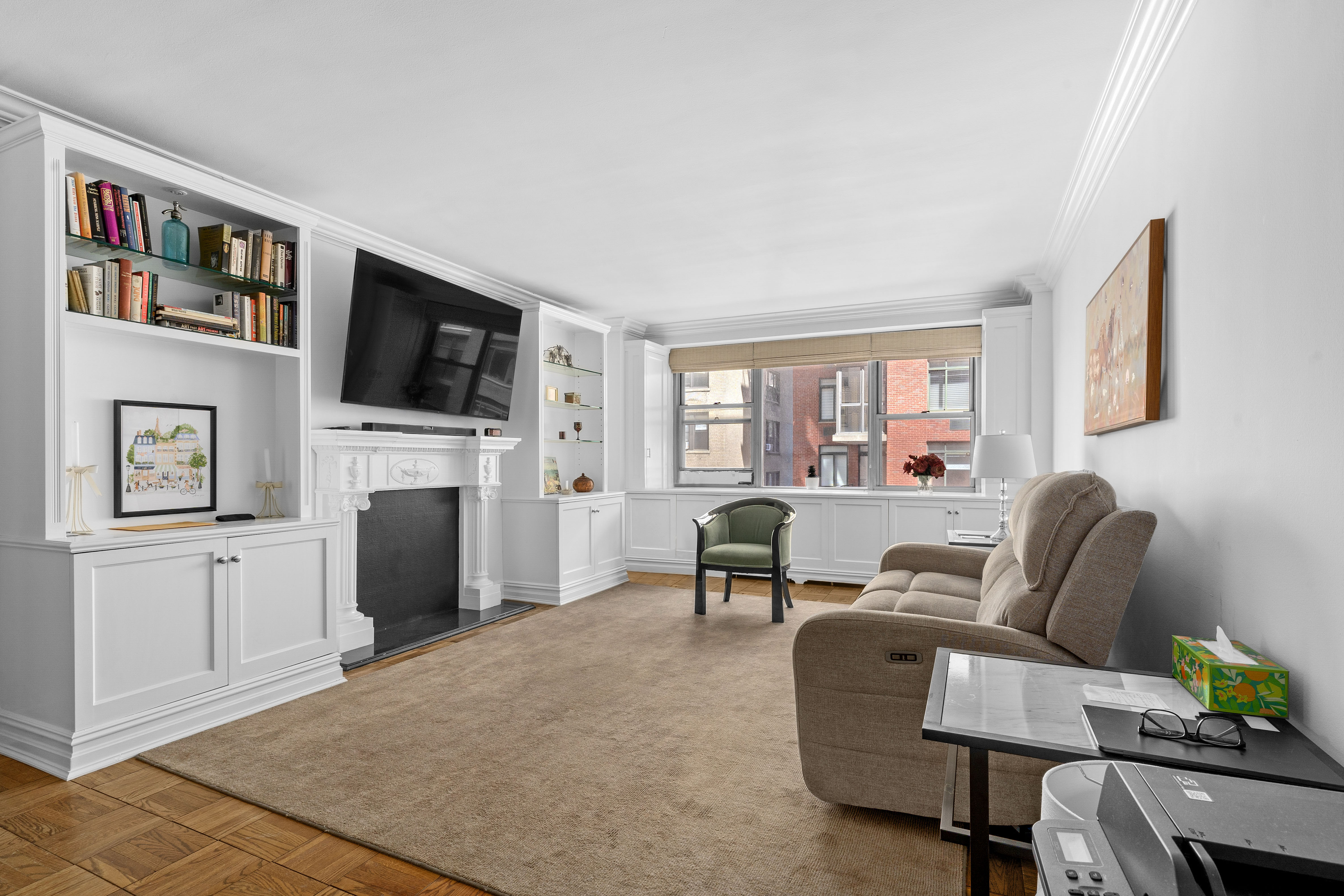 55 East 87th Street, Unit 5M Manhattan, NY 10128 - Photo 4 of 10 a living room with furniture a flat screen tv and a fireplace
