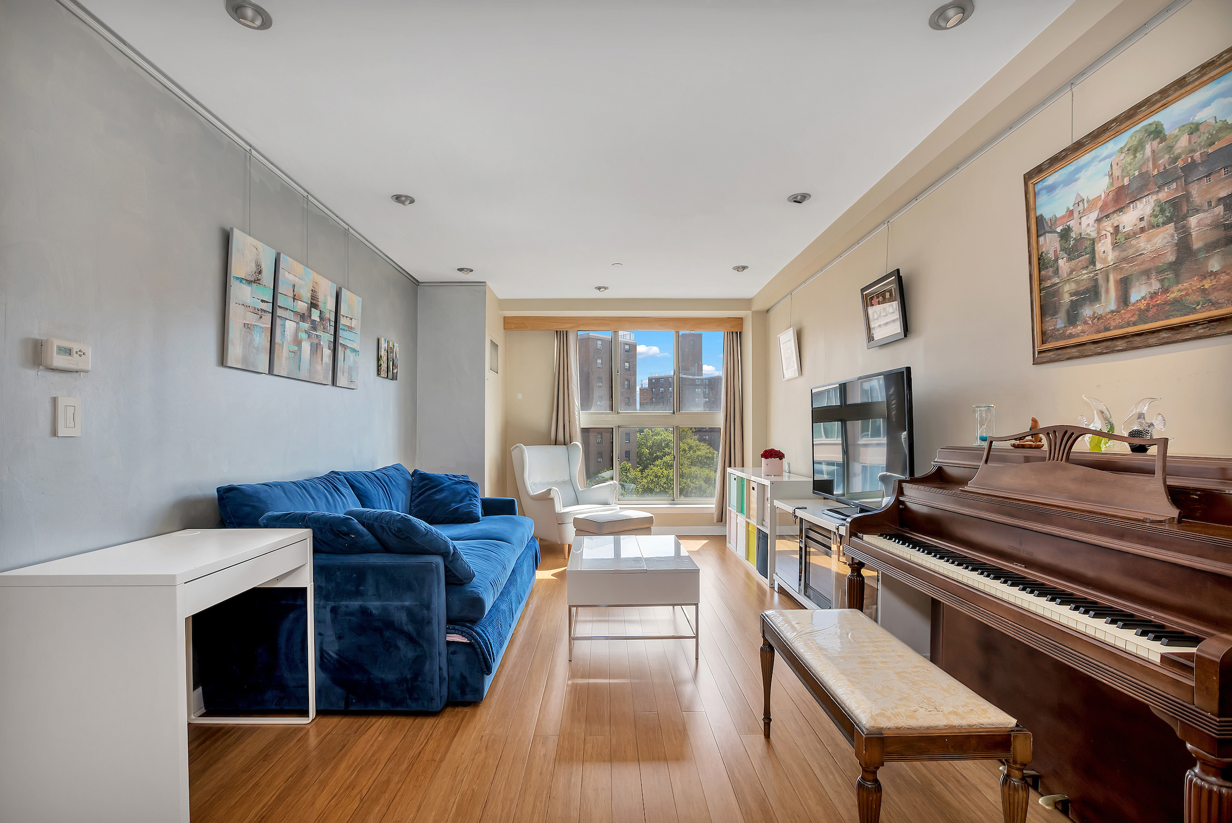 a living room with furniture fireplace and a large window