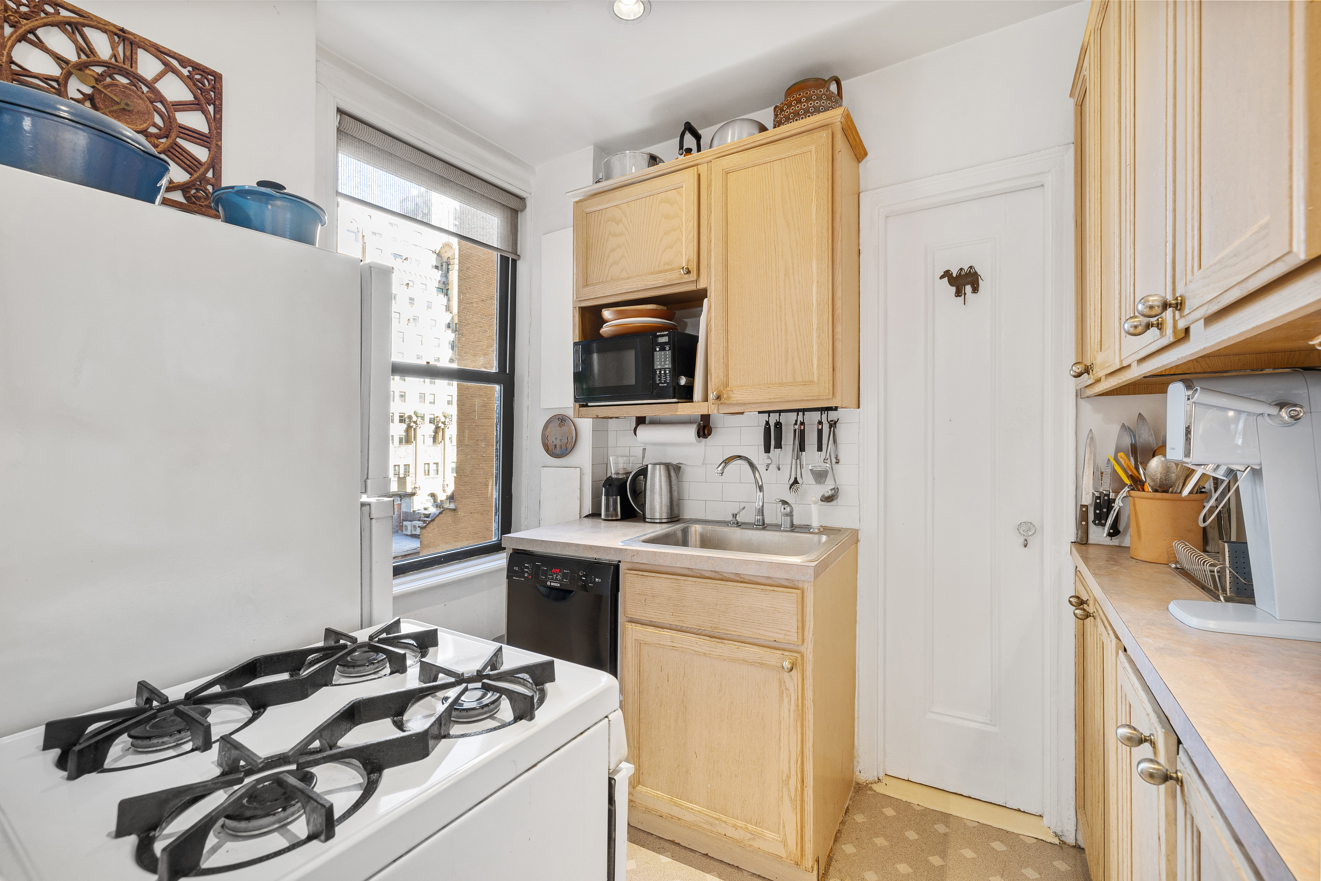 269 West 72nd Street, Unit 9B Manhattan, NY 10023 - Photo 6 of 13 a kitchen with a sink stove and refrigerator