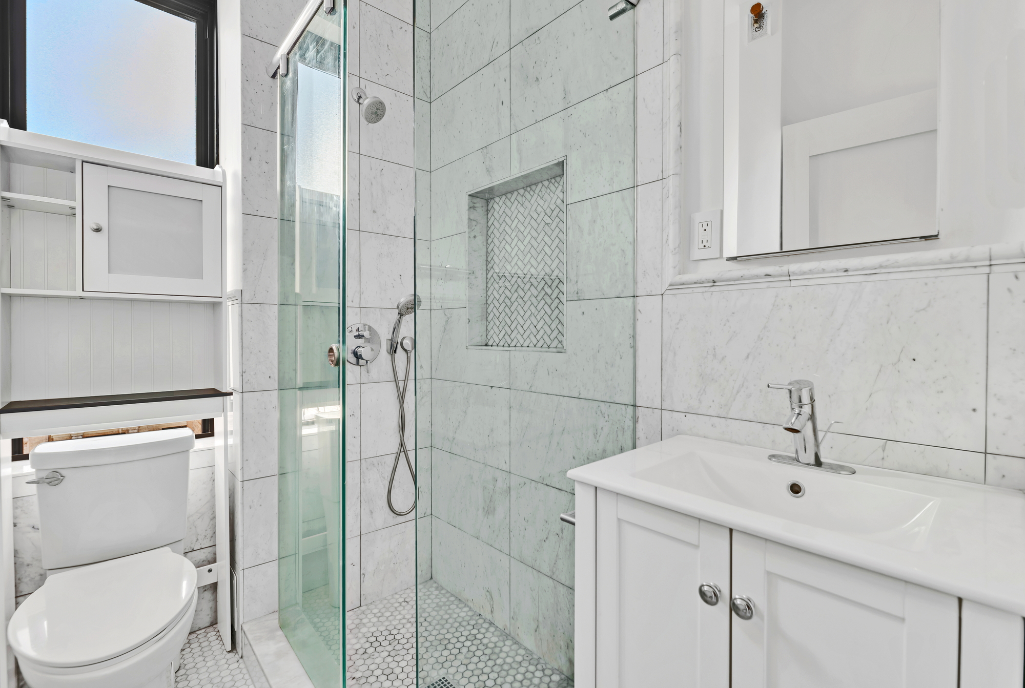 545 West 111th Street, Unit 10G Manhattan, NY 10025 - Photo 5 of 12 a bathroom with a sink a toilet and shower