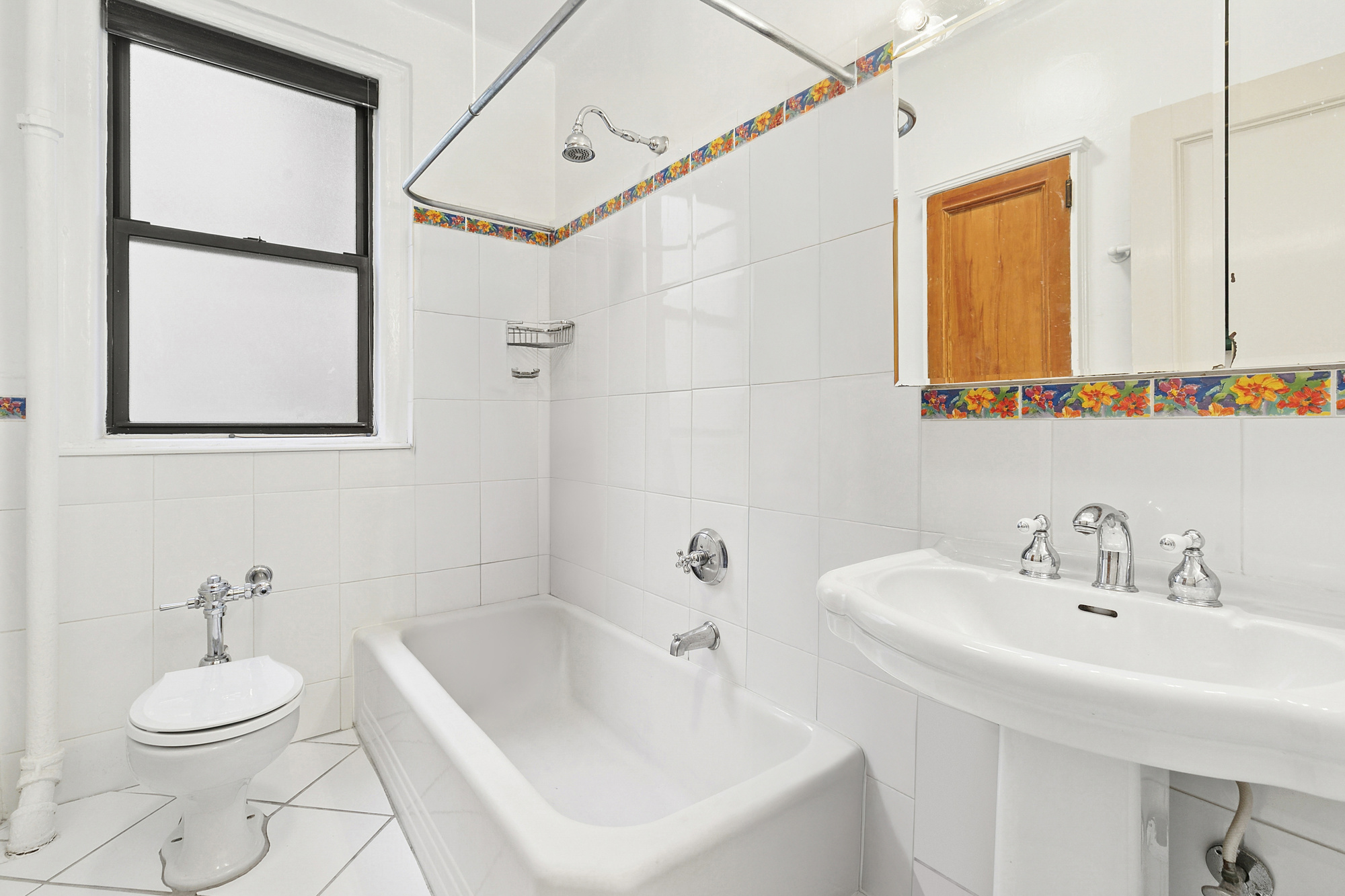 160 West 95th Street, Unit 4A Manhattan, NY 10025 - Photo 5 of 10 a bathroom with a sink a toilet and a mirror