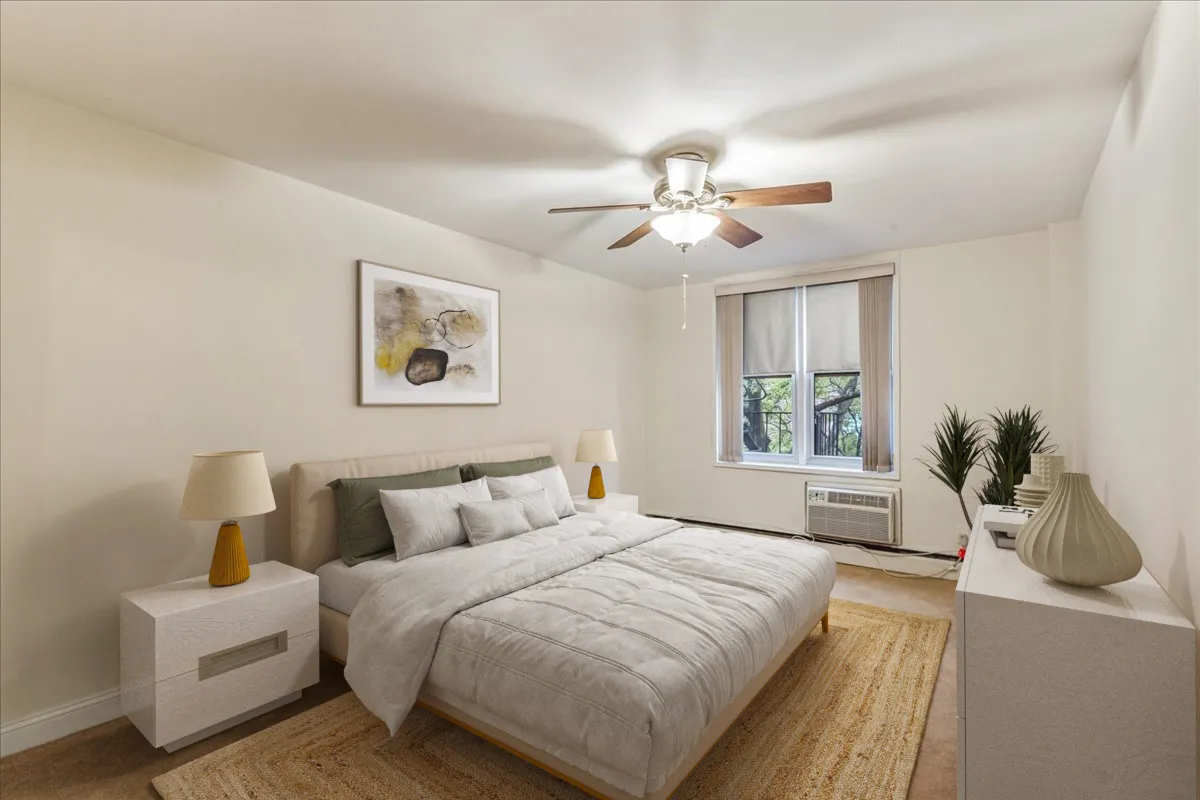 an empty room with windows and ceiling fan