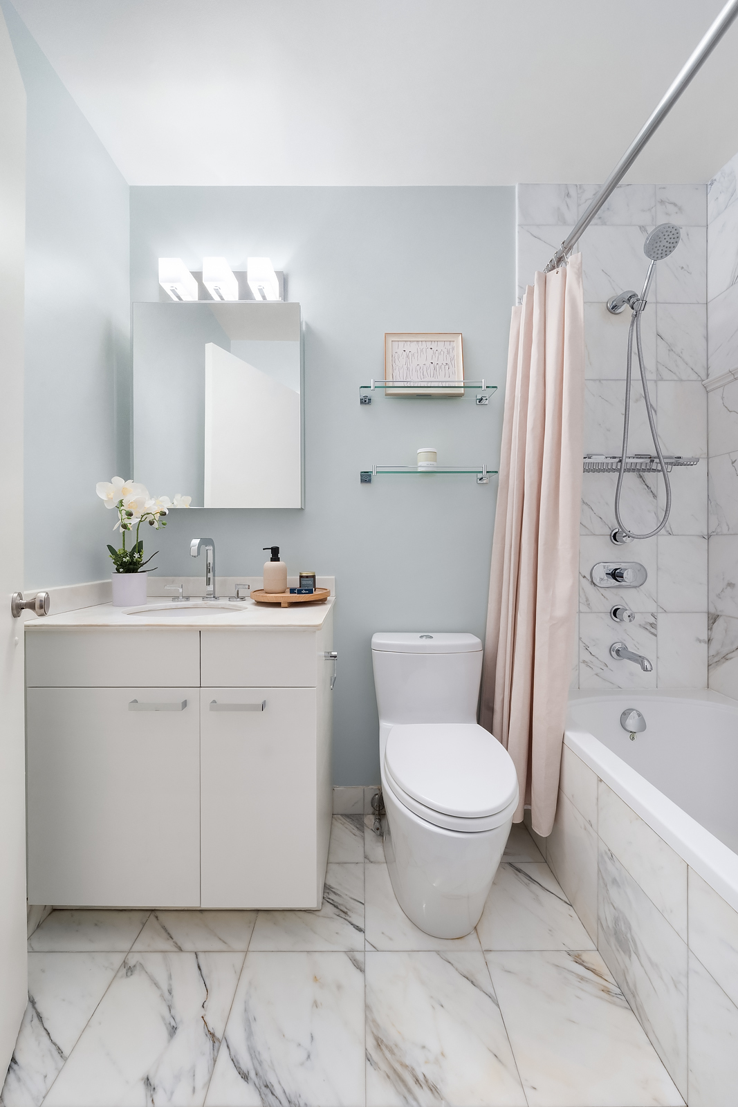 225 West 83rd Street, Unit 8L Manhattan, NY 10024 - Photo 11 of 18 a bathroom with a sink toilet and shower