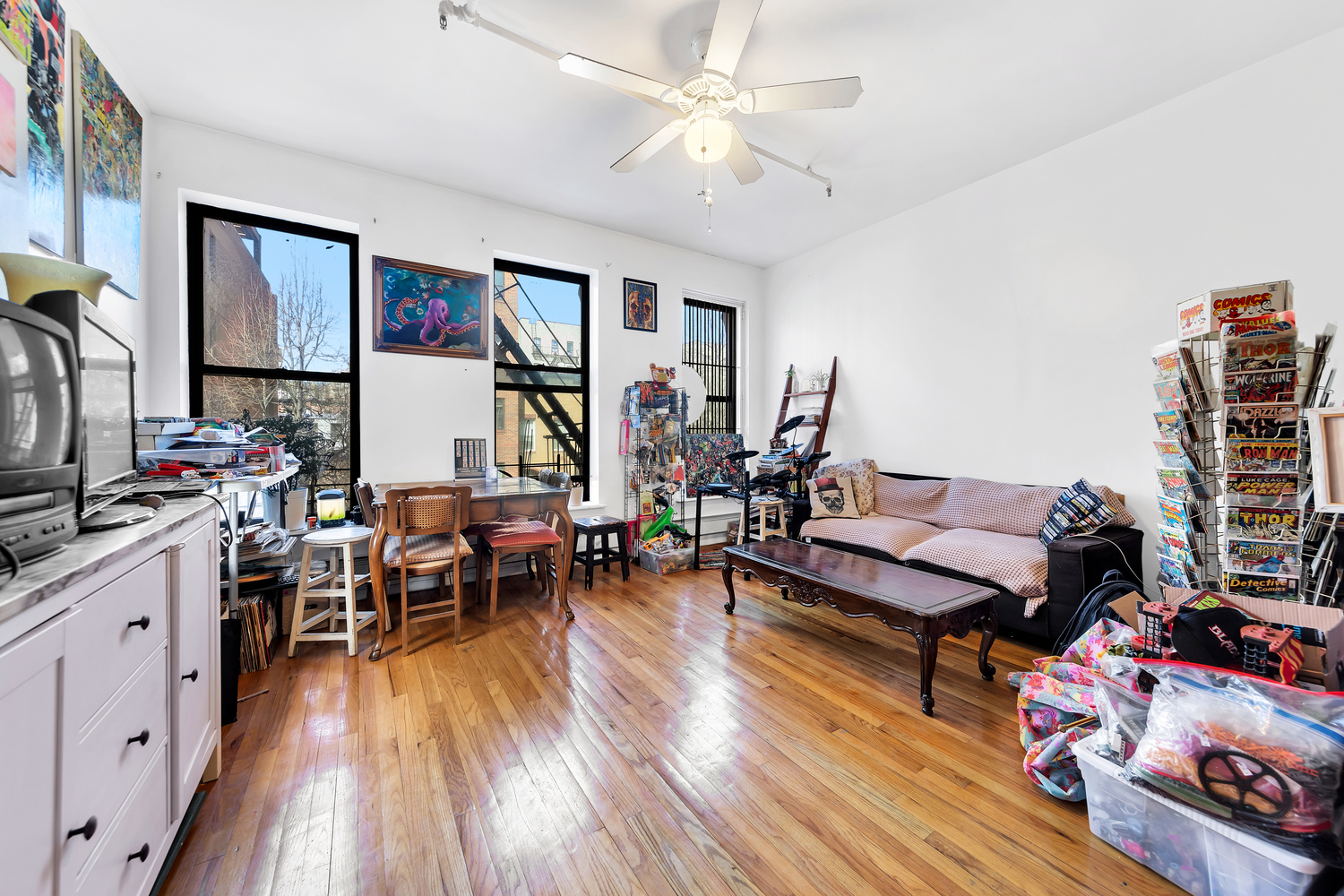 420 East 117th Street Manhattan, NY 10035 - Photo 3 of 11 a living room with furniture and wooden floor