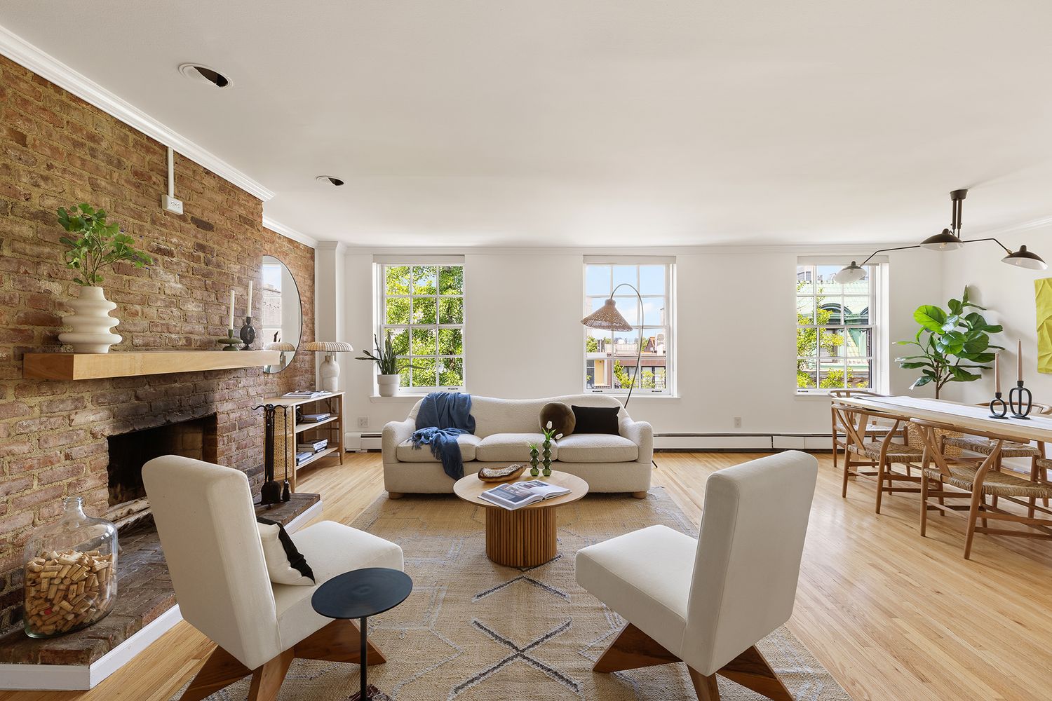 a living room with fireplace furniture and a large window