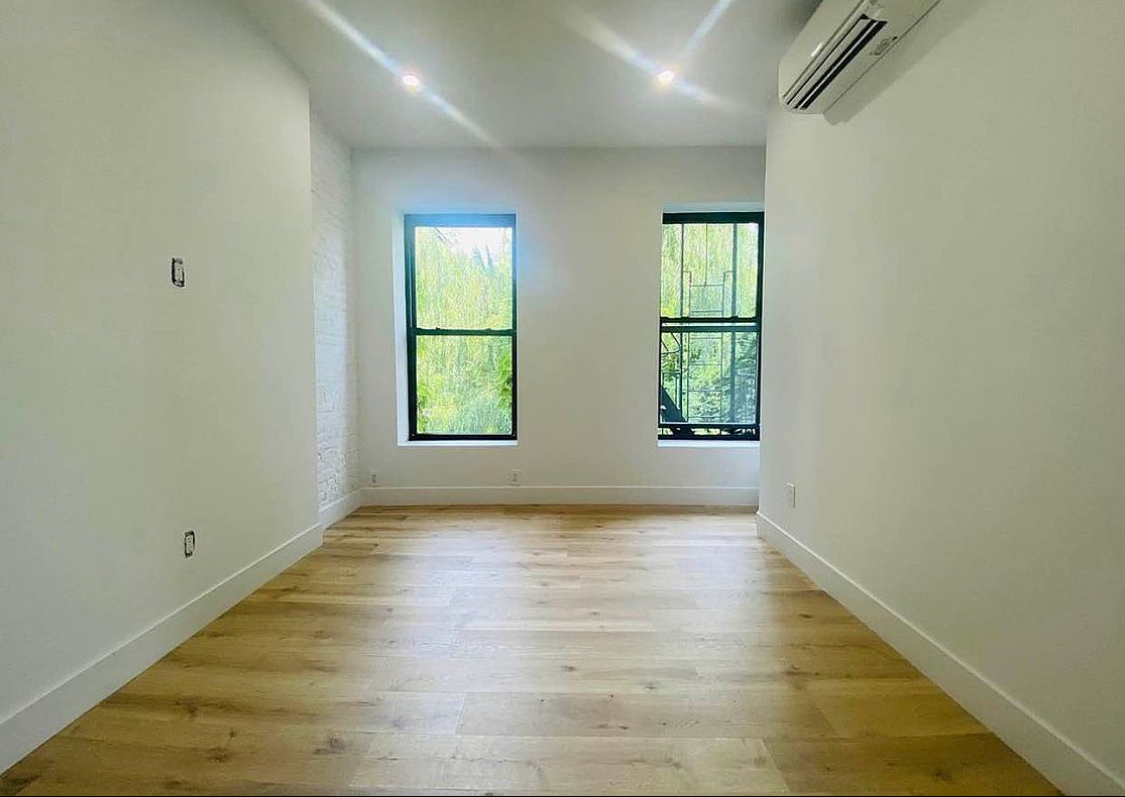 180 5th Avenue, Unit 3 Brooklyn, NY 11217 - Photo 9 of 13 an empty room with wooden floor and windows