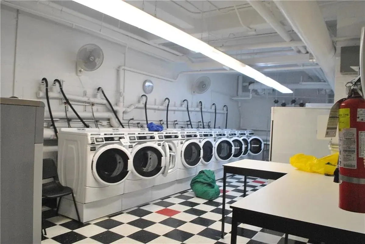 a utility room with dryer washer and a table