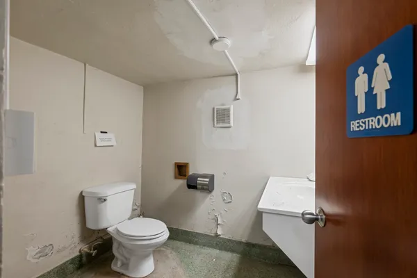 a room with view of kitchen with sink and living room
