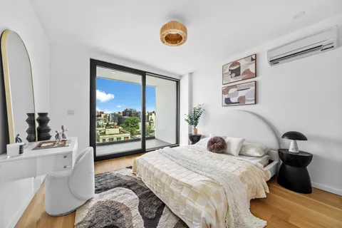 a bedroom with a bed and a large window