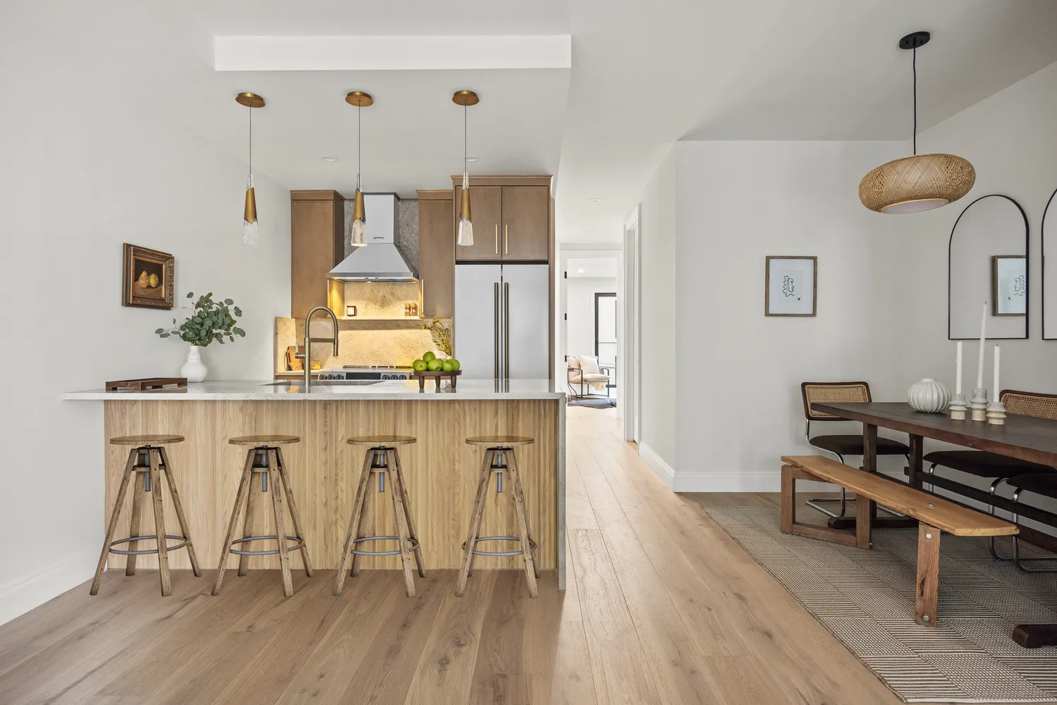 a living room with table chairs and a wooden floor