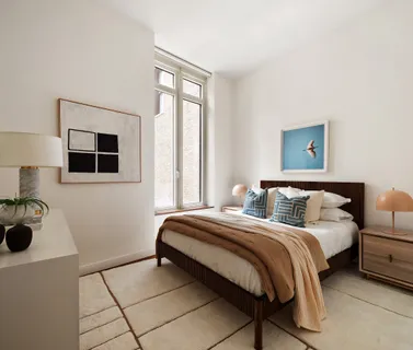 a bedroom with a bed and a lamp