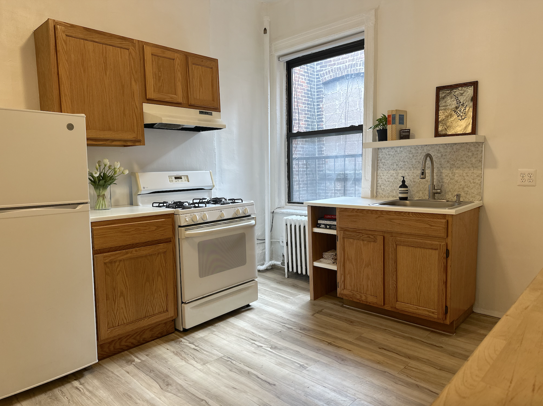 458 West 57th Street, Unit 5FE Manhattan, NY 10019 - Photo 1 of 14 a kitchen with a sink a stove and cabinets