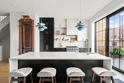 a kitchen with a table chairs stove and sink