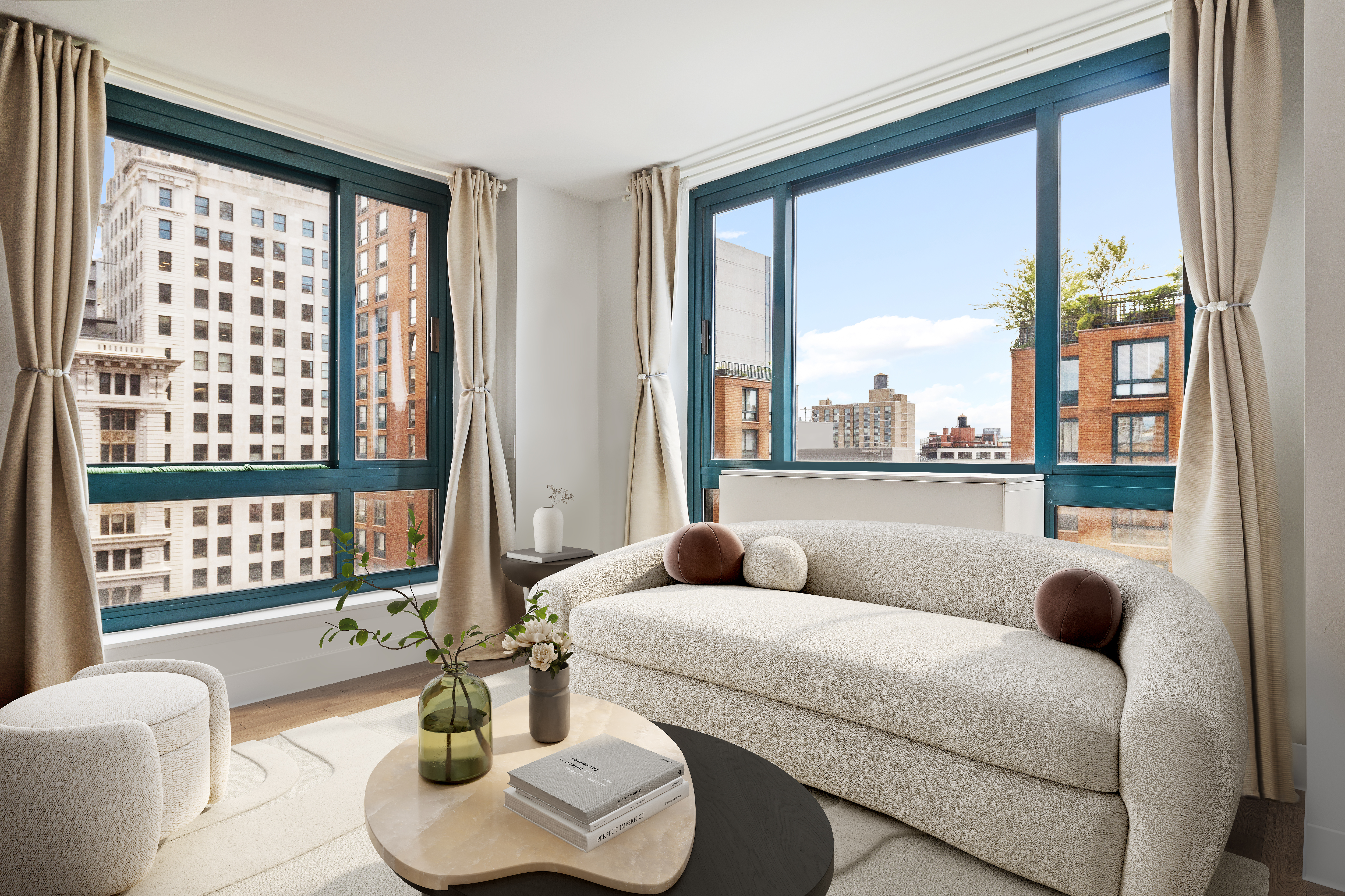 a living room with furniture and a floor to ceiling window