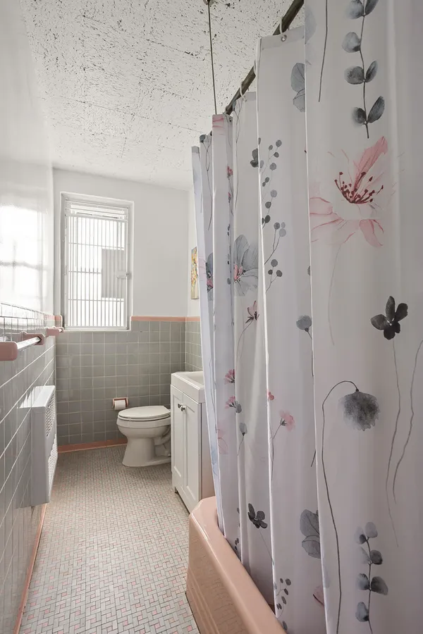 a bathroom with a toilet sink and shower