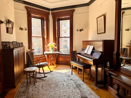 a view of a dining room with furniture and window