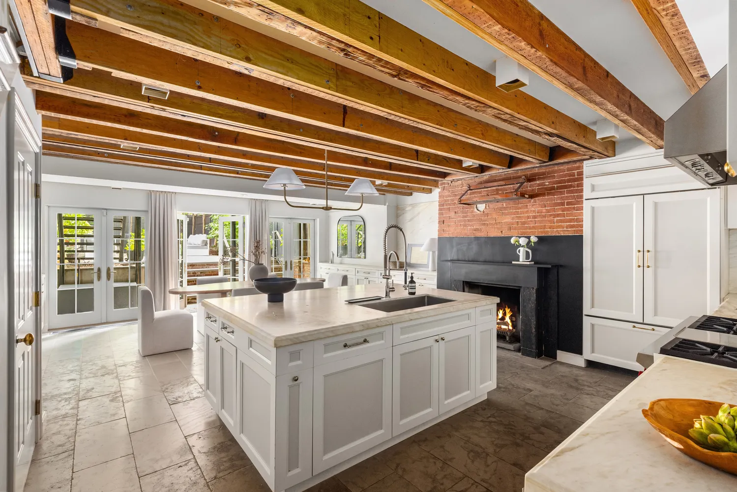 a large white kitchen with a stove a sink and a refrigerator