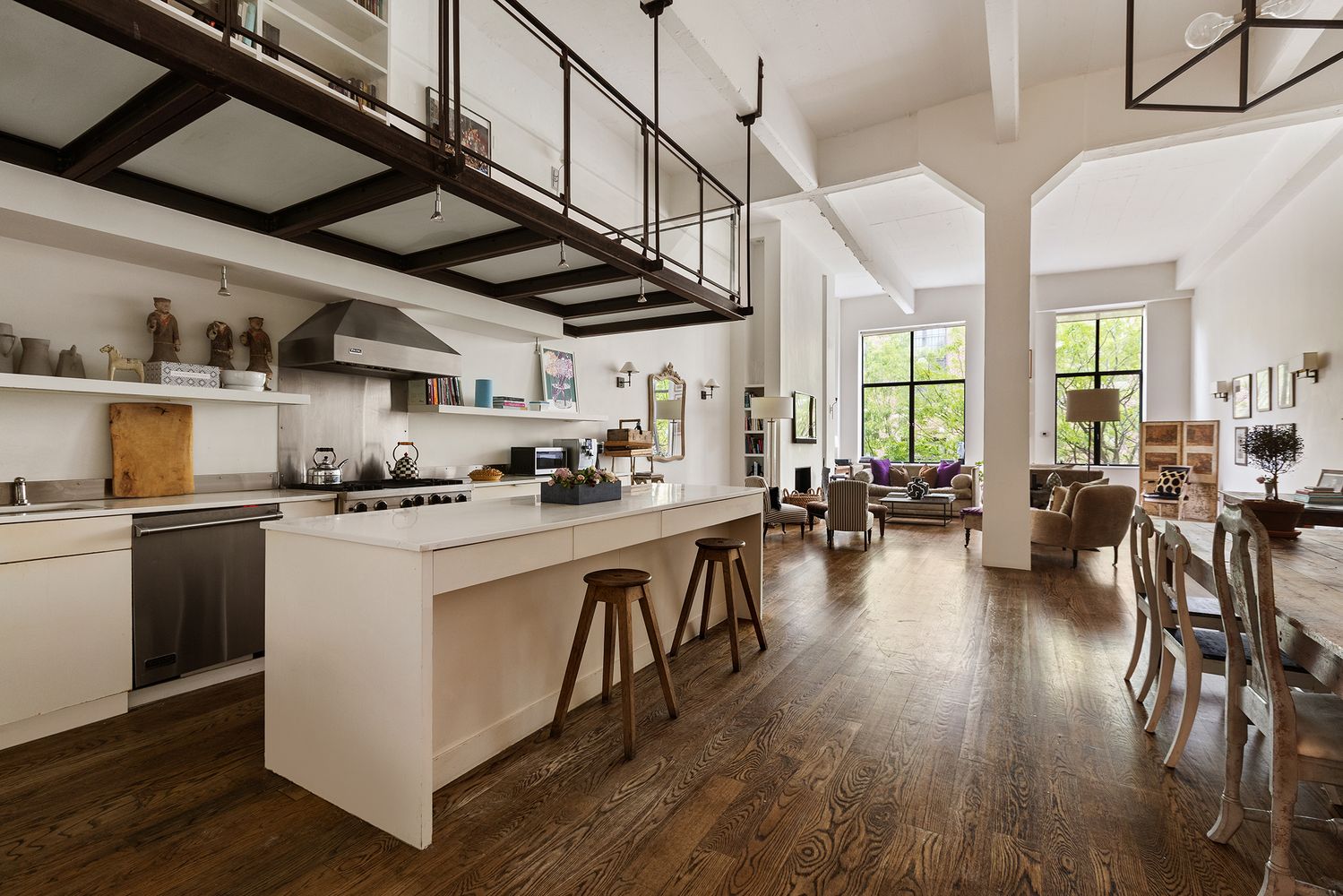 a kitchen with lots of counter top space and wooden floors