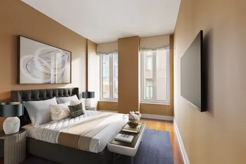 a bedroom with furniture and a large window