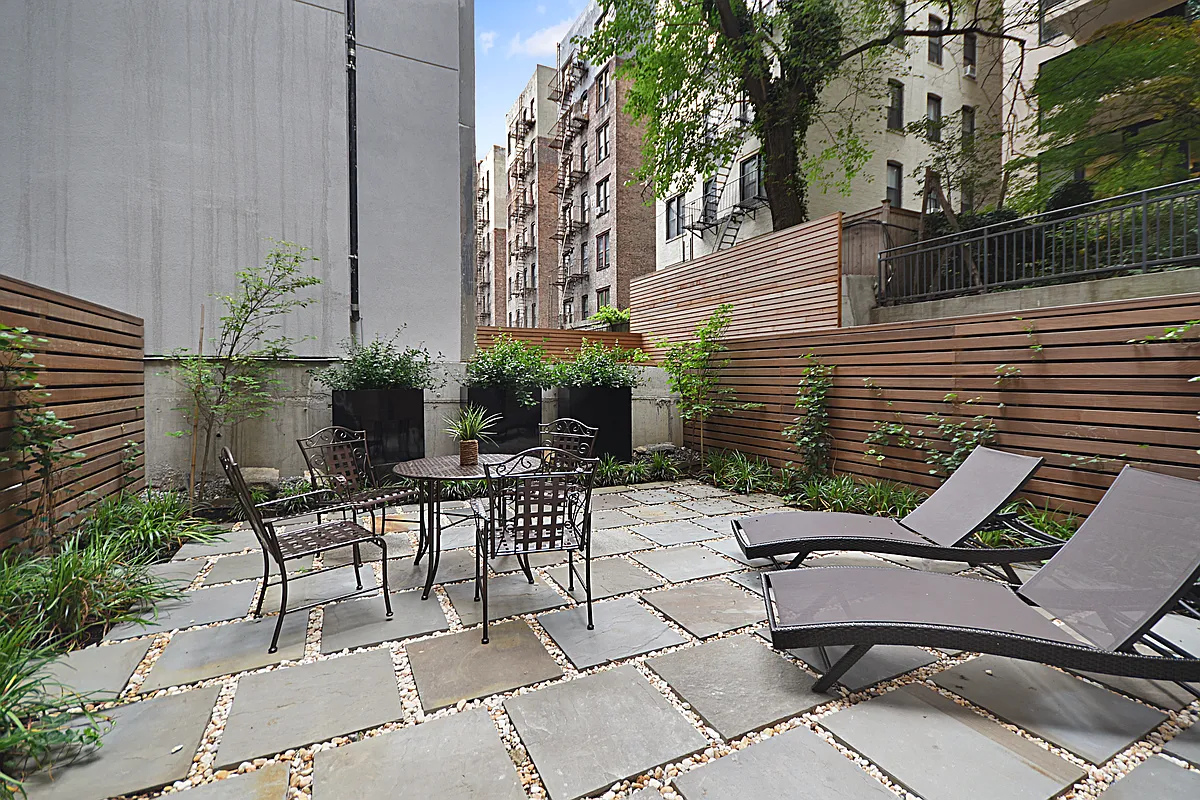 245 East 35th Street, Unit 9D Manhattan, NY 10016 - Photo 6 of 8 a view of a patio with table and chairs and potted plants