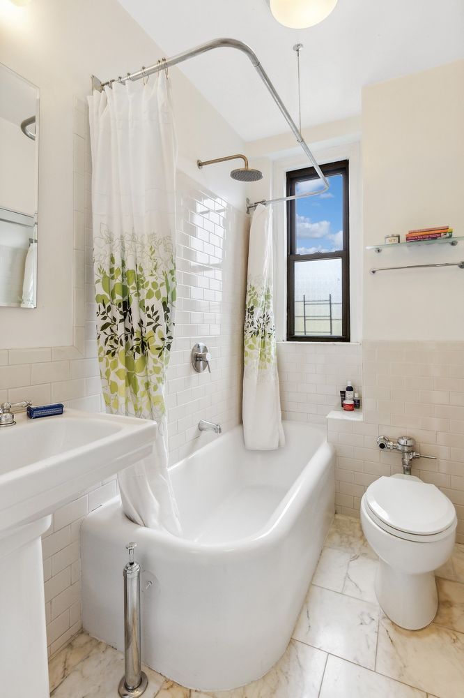 a bathroom with a white bath tub a toilet and a sink