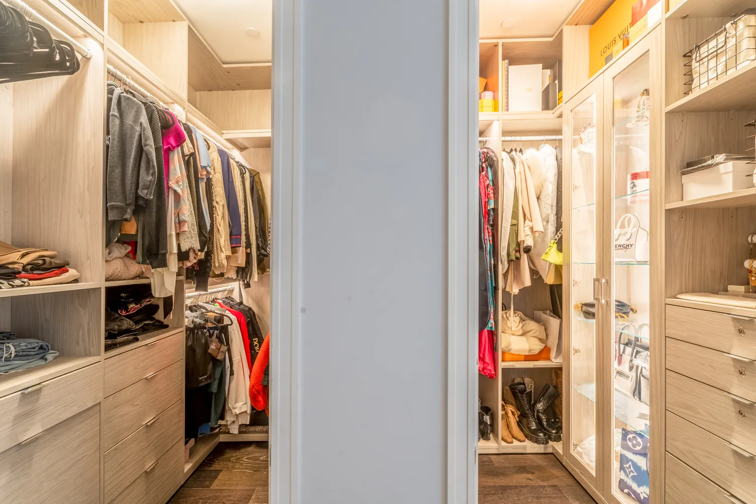 a view of walk in closet with clothes and shoes