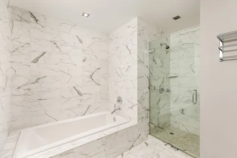 a bathroom with a bathtub and shower