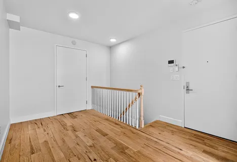 a view of a room with wooden floor