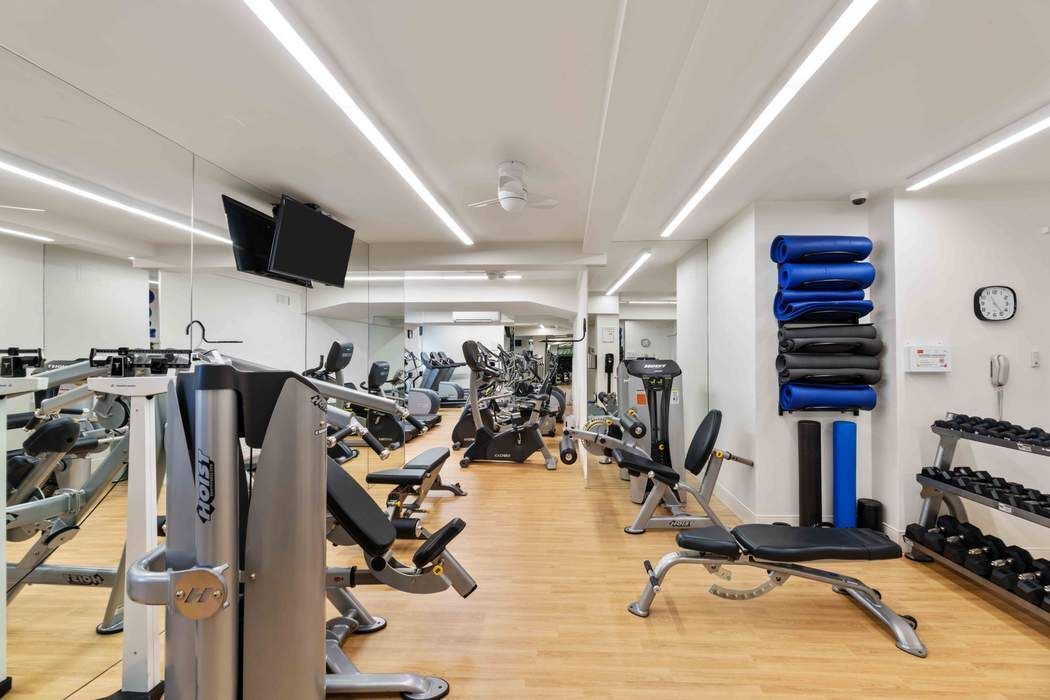 45 Sutton Place South, Unit 9O Manhattan, NY 10022 - Photo 13 of 16 a view of a room with gym equipment