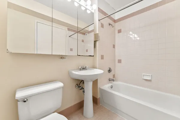 a bathroom with a sink a toilet and bathtub