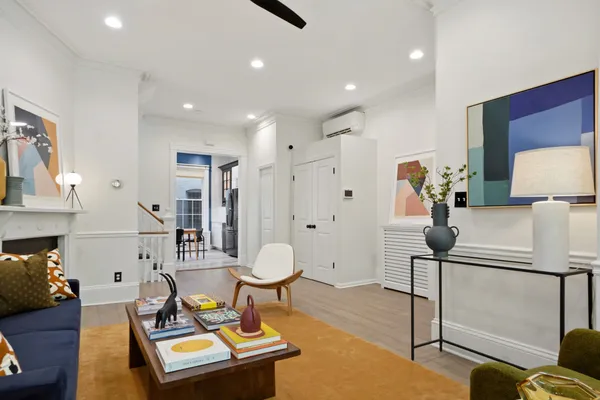 a living room with furniture a rug and a lamp