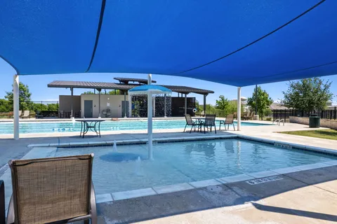 a view of a swimming pool with outdoor seating