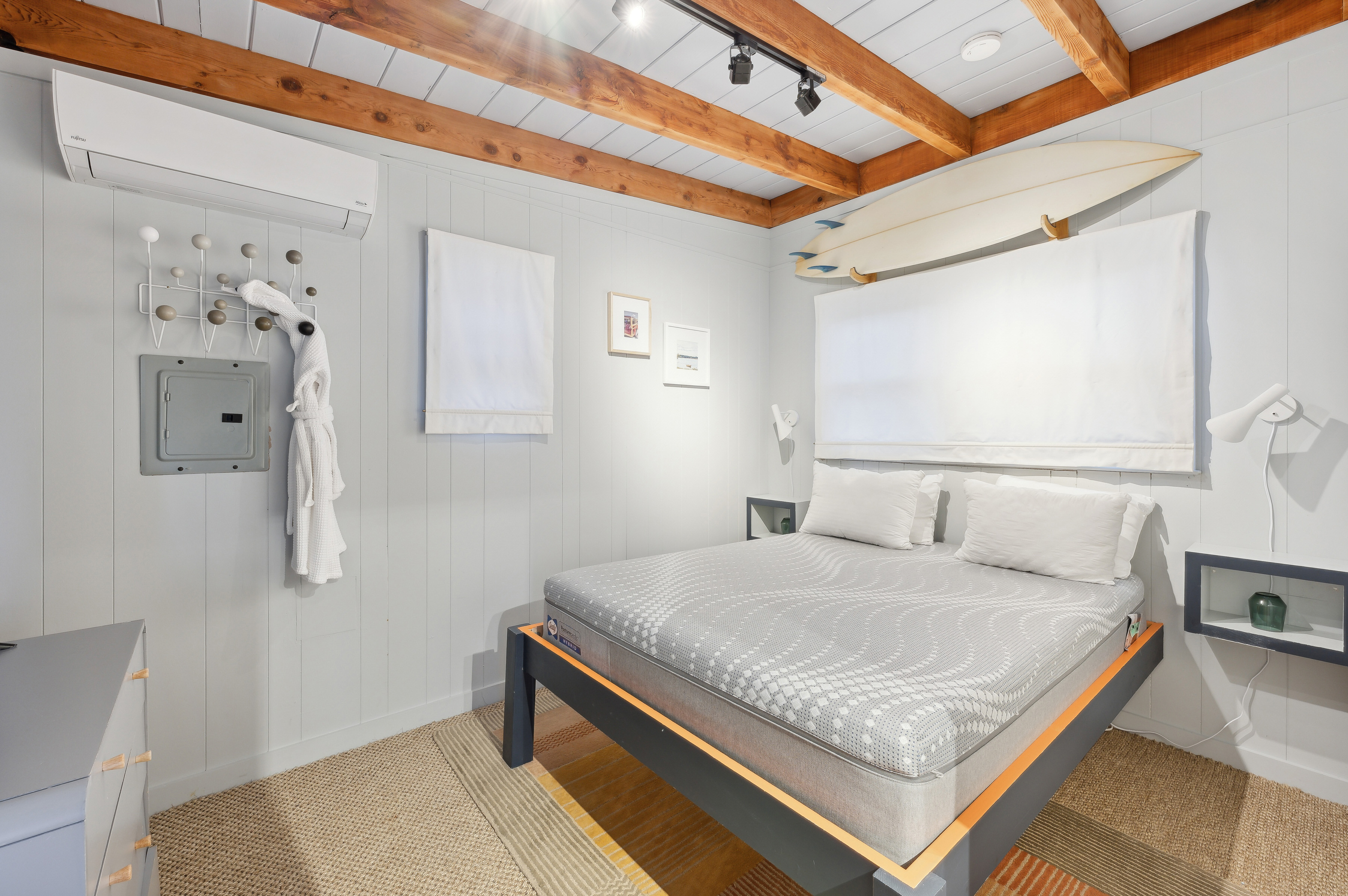 32 Lighthouse Road Hampton Bays, NY 11946 - Photo 45 of 51 a bedroom with a bed and a mirror