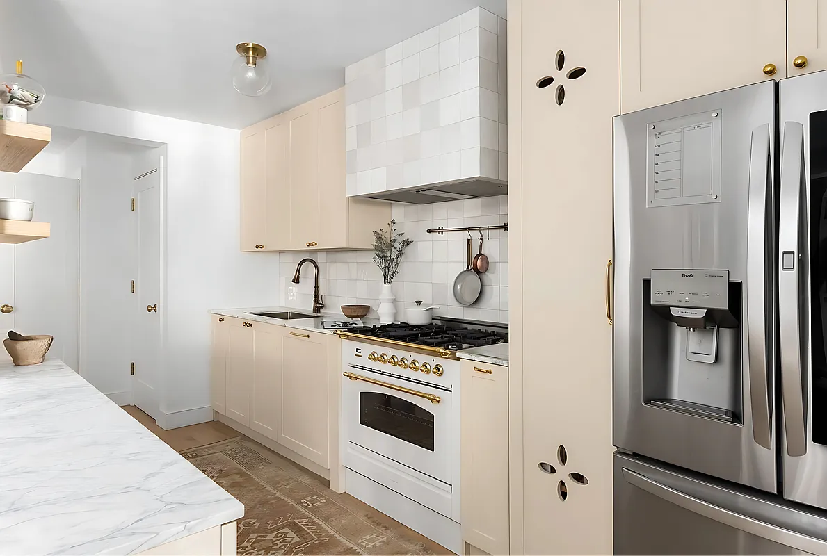 135 East 83rd Street, Unit 8/9C Manhattan, NY 10028 - Photo 5 of 15 a kitchen with a stove and a refrigerator